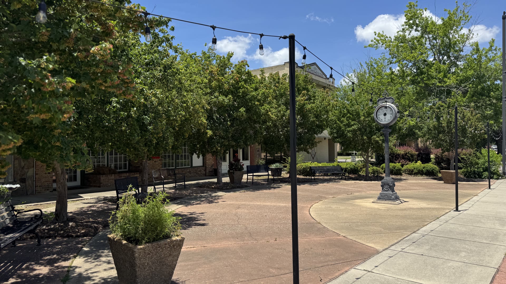 Downtown Moss Point's Main Street plaza, with storefronts and the street clock